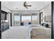 Bright bedroom with ceiling fan, dresser, and sliding glass doors to a balcony at 503 Aaron Way, Boulder City, NV 89005