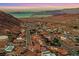 Expansive aerial shot of a quaint desert community boasting views of mountains and a serene lake at 503 Aaron Way, Boulder City, NV 89005