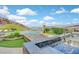 Covered outdoor kitchen area with a stunning infinity pool and endless views of the mountains and lake at 503 Aaron Way, Boulder City, NV 89005
