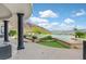 Backyard infinity pool with a travertine deck overlooking scenic mountain views and lush landscaping at 503 Aaron Way, Boulder City, NV 89005