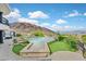 Beautiful backyard pool with manicured green areas, mountain views, and ample space for outdoor enjoyment at 503 Aaron Way, Boulder City, NV 89005