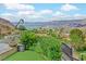 Lush backyard with a view of Lake Las Vegas, palm trees and manicured landscaping at 503 Aaron Way, Boulder City, NV 89005