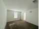 A well-lit bedroom with plush carpeting, a window, and access door at 5179 Silica Chalk Ave, Las Vegas, NV 89115