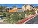 Landscaped entrance to the Cliffs at Dover community with stone signage and vibrant foliage at 5179 Silica Chalk Ave, Las Vegas, NV 89115
