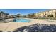 Large community pool with lounge chairs surrounded by well maintained landscaping at 5179 Silica Chalk Ave, Las Vegas, NV 89115