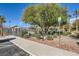 Exterior view of community pool and parking area surrounded by mature landscaping at 5179 Silica Chalk Ave, Las Vegas, NV 89115