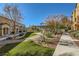 A well maintained outdoor community space offers covered seating and lush landscaping at 5179 Silica Chalk Ave, Las Vegas, NV 89115
