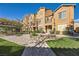 Home's exterior featuring landscaping, a balcony, and a pergola-covered seating area with picnic benches at 5179 Silica Chalk Ave, Las Vegas, NV 89115