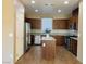 Modern kitchen with stainless steel appliances, granite counters, a kitchen island, and wood-look flooring at 5179 Silica Chalk Ave, Las Vegas, NV 89115