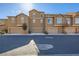 Exterior shot showcasing modern townhomes with attached garages along a clean, quiet street at 5179 Silica Chalk Ave, Las Vegas, NV 89115