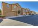 Charming street view of modern townhomes featuring attached garages and well-maintained landscaping at 5179 Silica Chalk Ave, Las Vegas, NV 89115