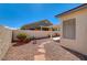 View of backyard showcasing a desert landscaped yard with stone pavers to the patio at 5419 Sharpei Ct, Las Vegas, NV 89131