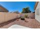 A gravel backyard is enclosed by a stucco wall, with desert landscaping at 5419 Sharpei Ct, Las Vegas, NV 89131