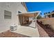 Covered backyard patio offers a tranquil outdoor living space with comfortable seating and desert landscaping at 5419 Sharpei Ct, Las Vegas, NV 89131