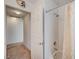Clean, white-tiled bathroom with shower and tub combination and access to an adjacent room at 5419 Sharpei Ct, Las Vegas, NV 89131