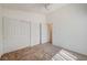 Well-lit bedroom features two large closets with a view into another room with neutral walls at 5419 Sharpei Ct, Las Vegas, NV 89131