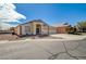 Single-story home featuring a spacious driveway, desert landscaping, and a three-car garage at 5419 Sharpei Ct, Las Vegas, NV 89131
