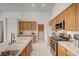 Bright kitchen features an island, stainless steel appliances, and wood cabinets at 5419 Sharpei Ct, Las Vegas, NV 89131