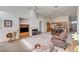 Open-concept living room with a fireplace and access to kitchen and dining area at 5419 Sharpei Ct, Las Vegas, NV 89131