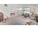 Open-concept living room featuring a vaulted ceiling, carpet flooring, and ample natural light at 5419 Sharpei Ct, Las Vegas, NV 89131