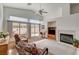 Living room with vaulted ceilings, fireplace, ceiling fan, and slider at 5419 Sharpei Ct, Las Vegas, NV 89131