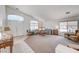 Spacious living room with vaulted ceiling, neutral carpet, and natural light from large windows at 5419 Sharpei Ct, Las Vegas, NV 89131
