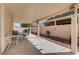 Covered patio area provides outdoor seating with views of the landscaped backyard and surrounding homes at 5419 Sharpei Ct, Las Vegas, NV 89131