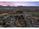 Wide aerial view of neighborhood with mountain views; includes a home with a private pool at 5690 N Park St, Las Vegas, NV 89149