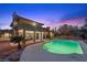 Beautiful backyard with a sparkling pool, covered patio, and desert landscaping at 5690 N Park St, Las Vegas, NV 89149