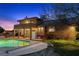 Backyard view with a pool, patio, and lush greenery, creating a serene outdoor space at 5690 N Park St, Las Vegas, NV 89149