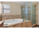 Bathroom featuring a jacuzzi tub and glass-enclosed shower at 5690 N Park St, Las Vegas, NV 89149