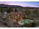 Illuminated two-story home features a balcony and a backyard with a pool at 5690 N Park St, Las Vegas, NV 89149