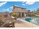Back of house featuring large pool, and upper story balcony at 5690 N Park St, Las Vegas, NV 89149