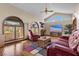Comfortable living room with vaulted ceilings, large windows and wood floors at 5690 N Park St, Las Vegas, NV 89149