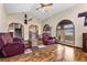 Bright living room featuring wood floors, vaulted ceilings, and large windows at 5690 N Park St, Las Vegas, NV 89149