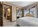 Main bedroom with large window, mirrored closet, and ensuite bathroom at 5690 N Park St, Las Vegas, NV 89149