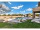 Backyard oasis featuring a sparkling pool surrounded by a lush lawn at 5690 N Park St, Las Vegas, NV 89149
