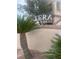 The Tera community signage with desert landscaping against a neutral color scheme adds welcoming curb appeal at 5751 E Hacienda Ave # 159, Las Vegas, NV 89122