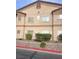 Traditional multi-Gathering building showing a tan stucco exterior, complemented by manicured landscaping and mature shrubbery at 5751 E Hacienda Ave # 159, Las Vegas, NV 89122