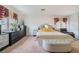 Bright bedroom featuring a luxurious bed, sleek dressers, and an inviting sitting area at 5771 Ritter Ln, Las Vegas, NV 89118