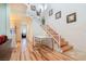 Bright dining area with modern table set, wooden stairs, and stylish decor at 5771 Ritter Ln, Las Vegas, NV 89118