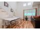 Inviting dining area with modern table, bright windows, and view of the staircase at 5771 Ritter Ln, Las Vegas, NV 89118