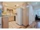 Bright kitchen with white appliances, tile flooring, and access to the bedroom at 5771 Ritter Ln, Las Vegas, NV 89118