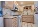 Cozy kitchen with wooden cabinets, white appliances, and ample counter space at 5771 Ritter Ln, Las Vegas, NV 89118