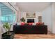 Relaxing living room featuring a plush sofa, large windows, and modern entertainment center at 5771 Ritter Ln, Las Vegas, NV 89118