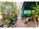 Landscaped patio with an outdoor bench and lots of greenery at 5771 Ritter Ln, Las Vegas, NV 89118