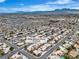 Aerial view of the home surrounded by a desert community with mountain views at 6405 Break Point Ave, Las Vegas, NV 89130