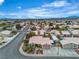 An aerial view showcases the home's location in a residential neighborhood, surrounded by desert landscape at 6405 Break Point Ave, Las Vegas, NV 89130