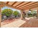 Backyard featuring a covered patio, fire pit, and mature landscaping for a relaxing retreat at 6405 Break Point Ave, Las Vegas, NV 89130