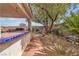 Inviting backyard featuring a built-in BBQ, desert landscaping, and covered patio at 6405 Break Point Ave, Las Vegas, NV 89130